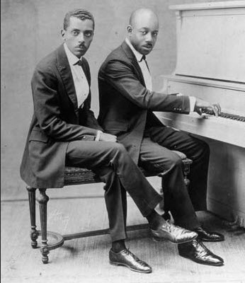 Black and white photo of Eubie Blake and Noble Sissle at a piano
