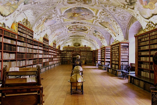 Photo of library with ornate decorations and paintings on ceiling and globes in the center