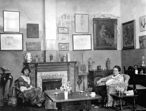 Gertrude Stein and Alice B Toklas seated in their living room at 92 rue de Fleurus