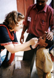 A young boy receiving oral polio vaccine in India