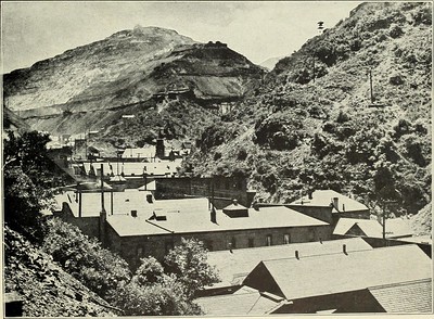 Black-and-white photo of Bingham Canyon circa 1920, showing rooftops of buildings and the steep mountainside