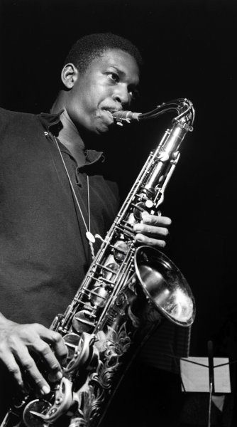 Black and white photo of John Coltrane playing saxophone