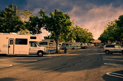 RVs and cars in store parking lot