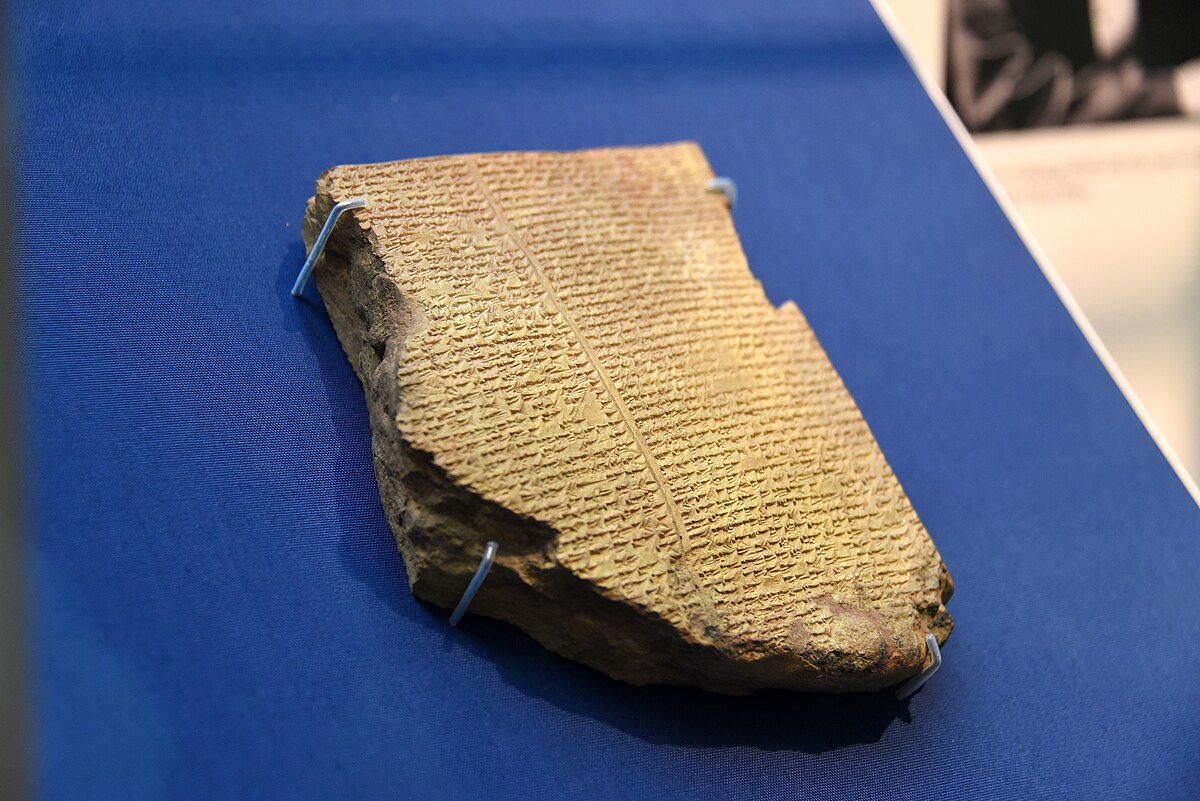 Tablet from Ashurbanipal's library, containing part of the Epic of Gilgamesh, displayed on a stand at the British Museum